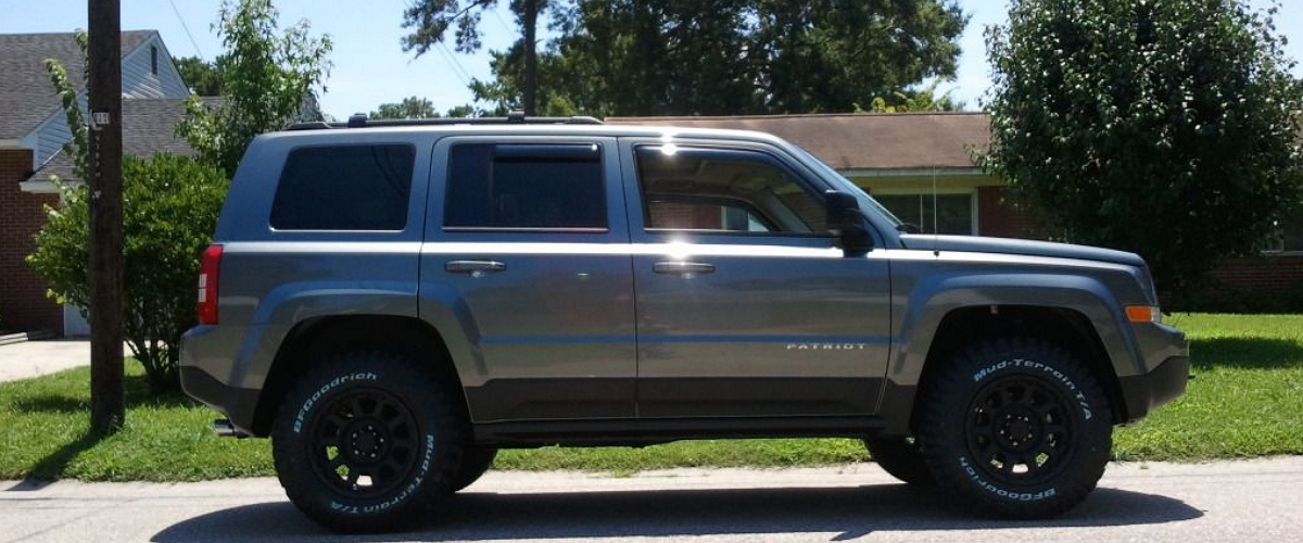Gray Lifted Jeep Patriot on Goodrich Mud Tires