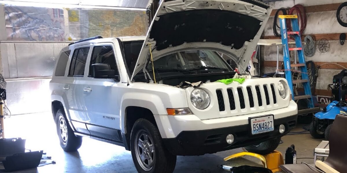 Jeep Patriot being repaired in a garage