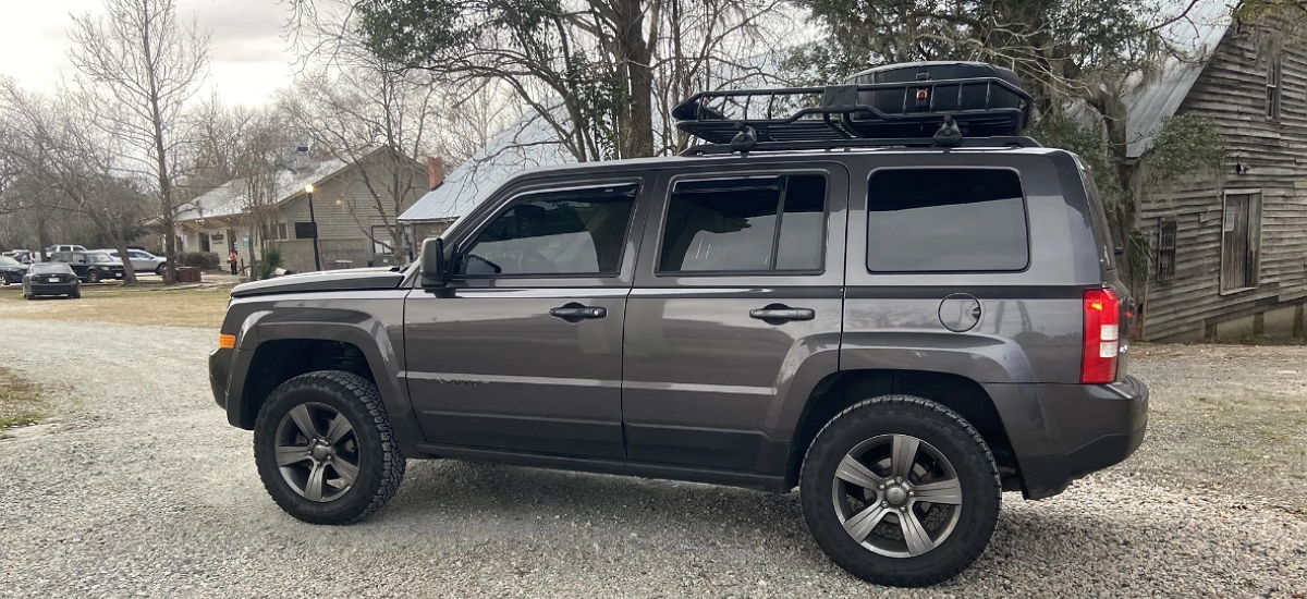 Lifted Gray Jeep Patriot with a Roof Rack