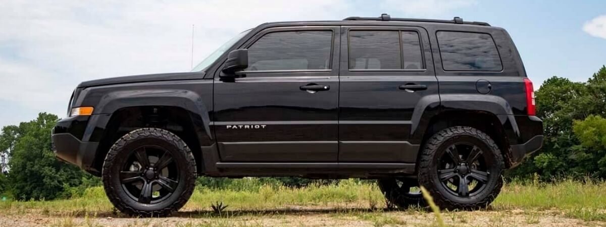 Lifted black Jeep Patriot with 2-inch lift kit installed