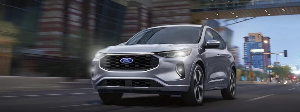 2024 Ford Escape driving along the night city road