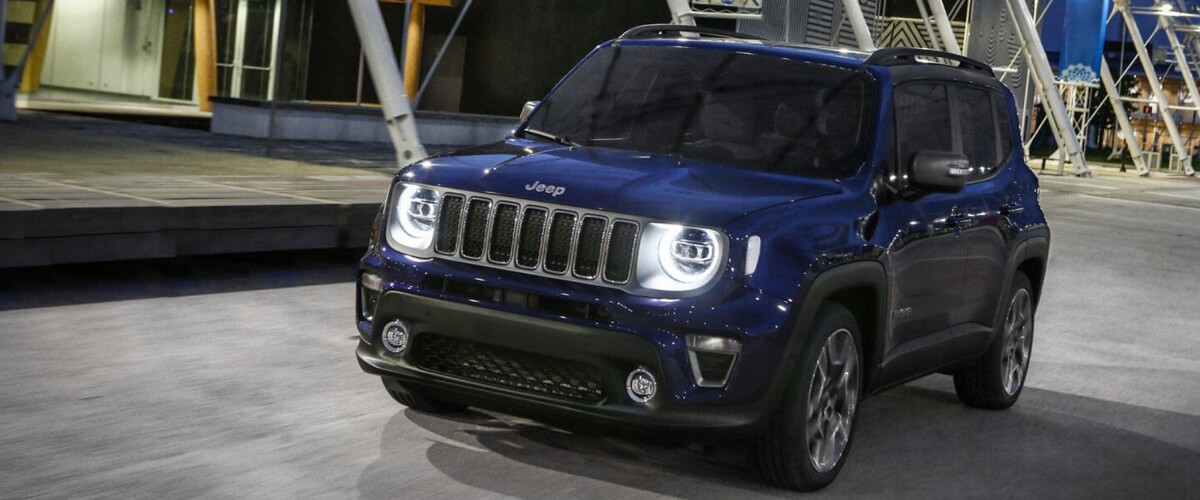 Black Jeep renegade driving at night in the city