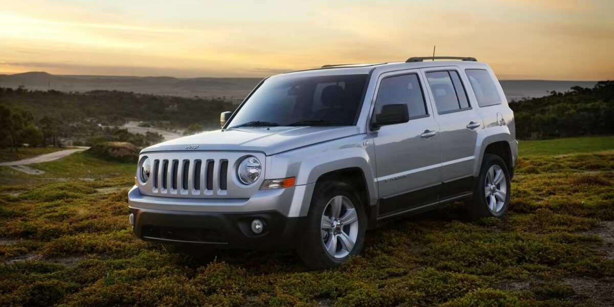 Gray 2015 Jeep Patriot gone off-road on factory alloy wheels